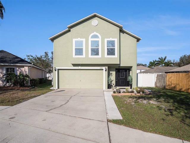 view of front of property featuring fence, a front lawn, concrete driveway, and stucco siding