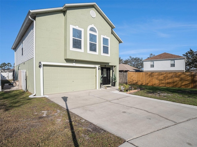 view of front of property with a garage, concrete driveway, fence, and stucco siding