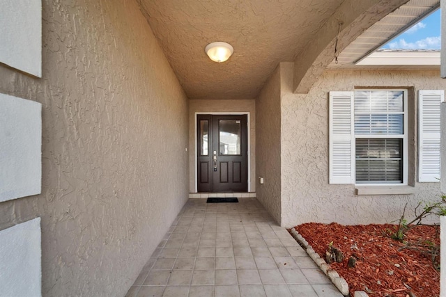 property entrance with stucco siding