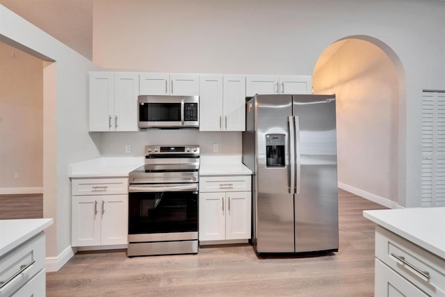 kitchen featuring stainless steel appliances, light wood-type flooring, and light countertops