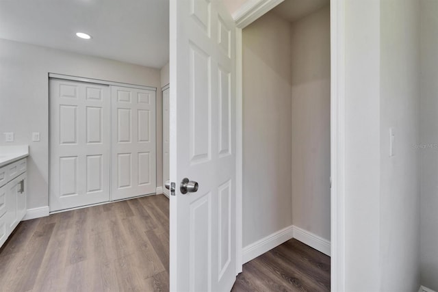 bathroom with recessed lighting, wood finished floors, vanity, and baseboards