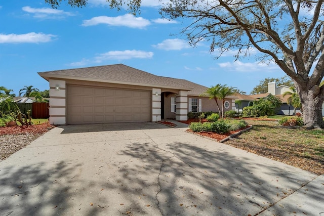 ranch-style house featuring a garage, concrete driveway, and stucco siding