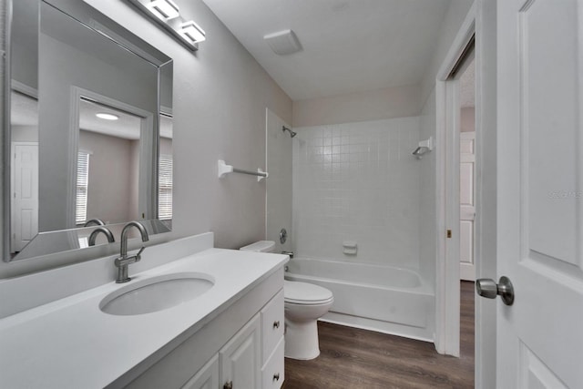 full bathroom featuring  shower combination, vanity, wood finished floors, and toilet