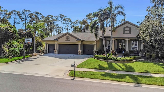 view of front facade featuring a garage, driveway, stone siding, stucco siding, and a front yard