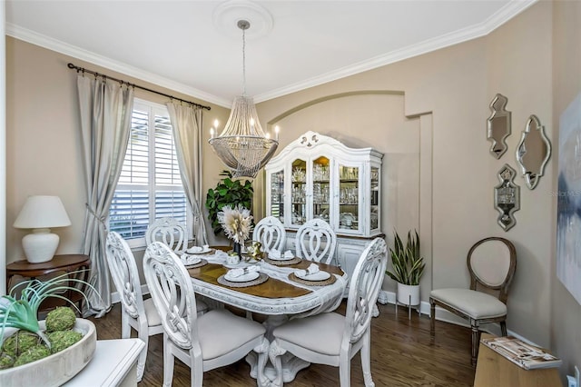 dining area featuring an inviting chandelier, ornamental molding, and wood finished floors