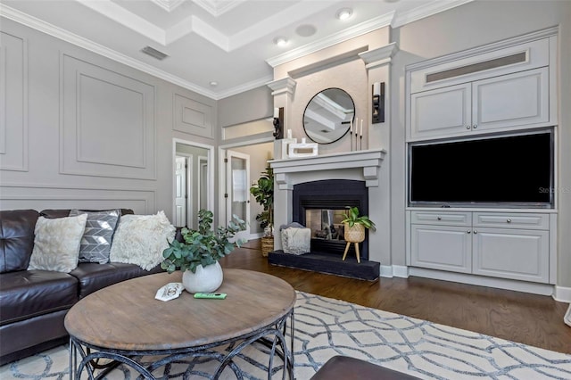 living room featuring dark wood-style flooring, visible vents, crown molding, and a multi sided fireplace