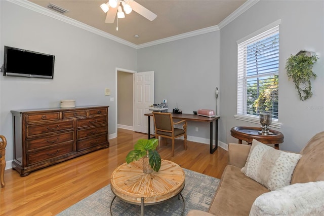 living area featuring crown molding, baseboards, visible vents, and light wood-style floors