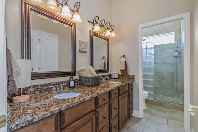 full bathroom featuring toilet, a shower stall, double vanity, and a sink