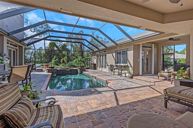 view of pool featuring french doors, a patio, a pool with connected hot tub, glass enclosure, and ceiling fan