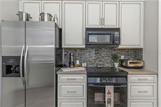 kitchen featuring light countertops, white cabinets, backsplash, and black appliances