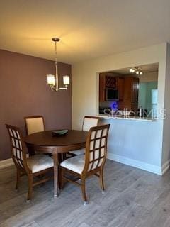 dining room featuring baseboards and wood finished floors