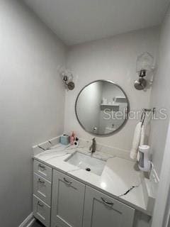 bathroom with vanity and baseboards