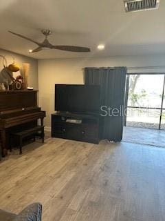 living area with recessed lighting, visible vents, ceiling fan, and wood finished floors