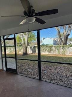 unfurnished sunroom featuring a ceiling fan