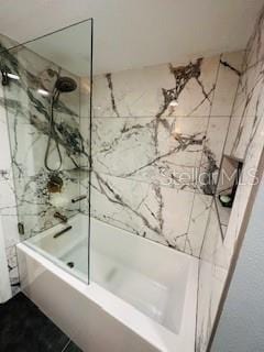 full bath featuring combined bath / shower with glass door