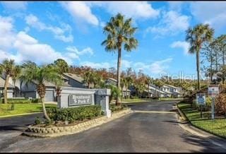 view of street featuring a residential view and a gated entry