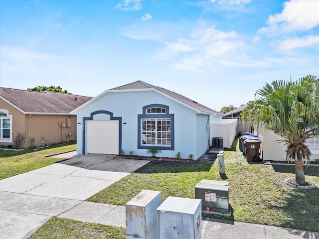 view of front of home featuring an attached garage, stucco siding, concrete driveway, and a front yard