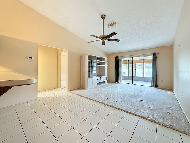 unfurnished living room featuring ceiling fan, a textured ceiling, light tile patterned flooring, light colored carpet, and visible vents