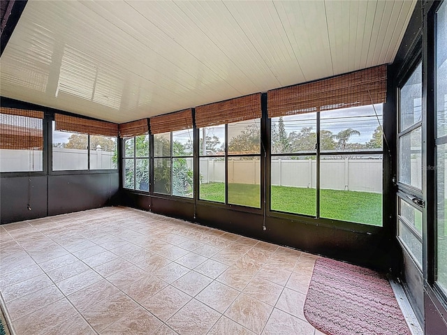 unfurnished sunroom featuring lofted ceiling