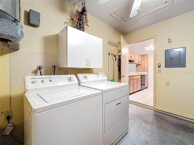 clothes washing area featuring a textured ceiling, cabinet space, washing machine and dryer, and electric panel