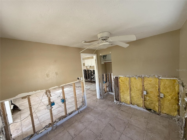 spare room featuring ceiling fan and a textured ceiling