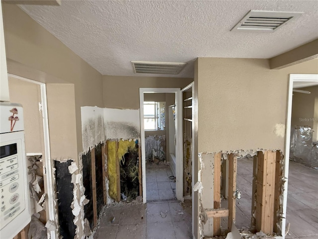 interior space with a textured ceiling and visible vents