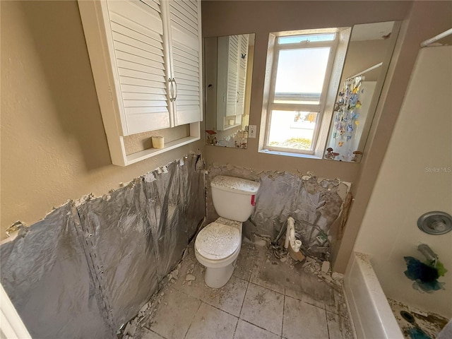 full bath with toilet and tile patterned floors