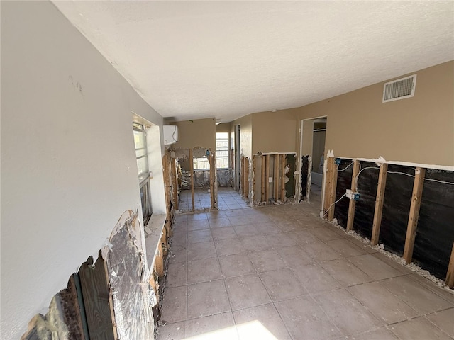 empty room featuring a textured ceiling and visible vents