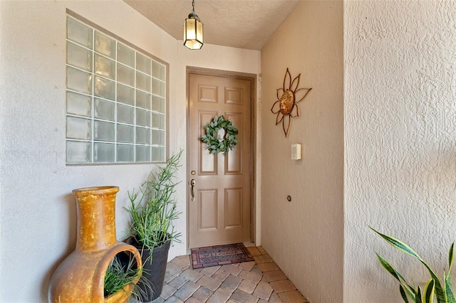 view of exterior entry with stucco siding