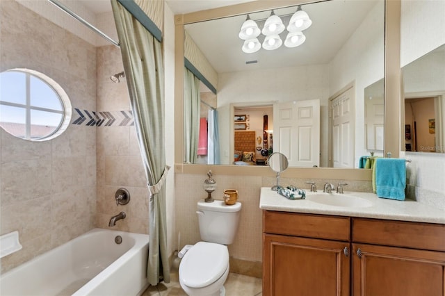 bathroom featuring shower / bath combo, vanity, toilet, and tile walls