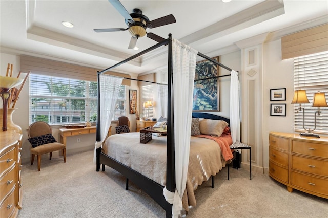 bedroom featuring a raised ceiling, light colored carpet, and crown molding