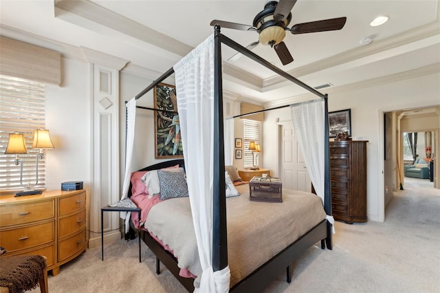 bedroom with light carpet, ceiling fan, ornamental molding, and a raised ceiling