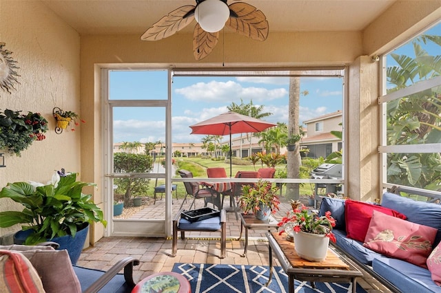 sunroom featuring a ceiling fan