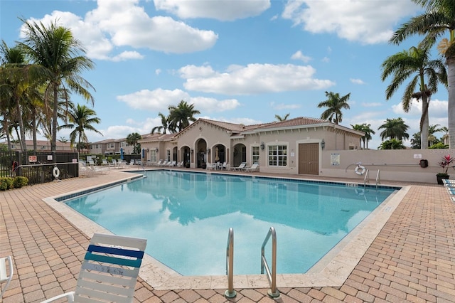 community pool featuring a patio area and fence