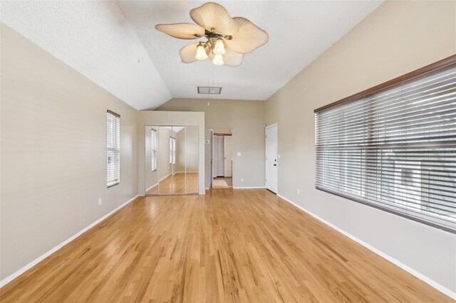 unfurnished living room with light wood finished floors, baseboards, visible vents, and a ceiling fan