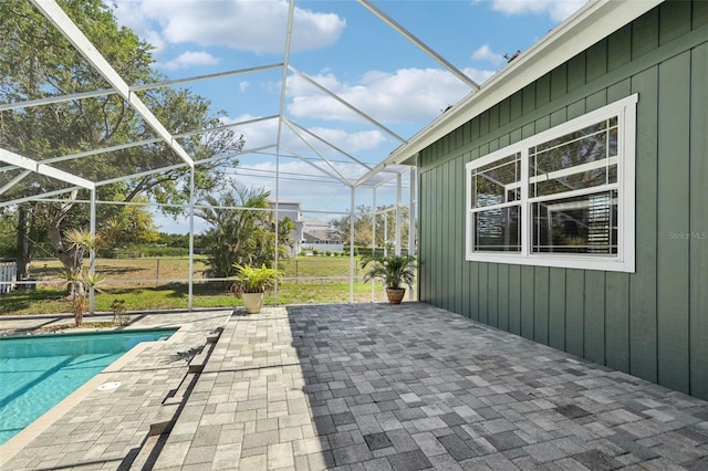 exterior space featuring glass enclosure and a patio