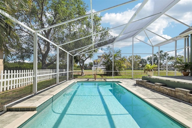 view of pool with a fenced in pool, a lanai, a patio area, and fence