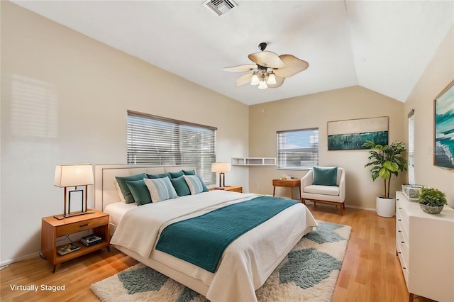 bedroom featuring baseboards, visible vents, a ceiling fan, lofted ceiling, and light wood-type flooring