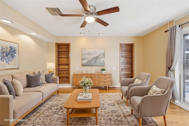 living room featuring recessed lighting, visible vents, ceiling fan, and light wood finished floors