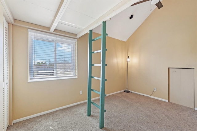 unfurnished bedroom featuring lofted ceiling with beams, carpet flooring, and baseboards