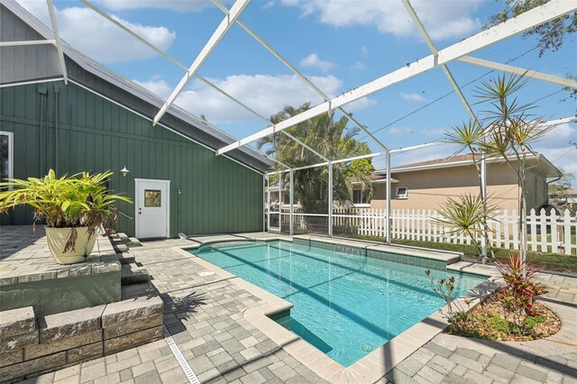 view of swimming pool featuring fence and a patio