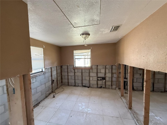 interior space featuring visible vents and a textured ceiling