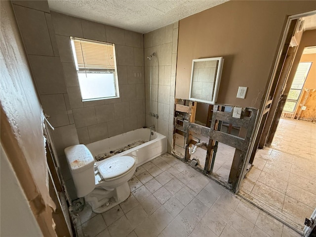 bathroom featuring a textured ceiling,  shower combination, and toilet