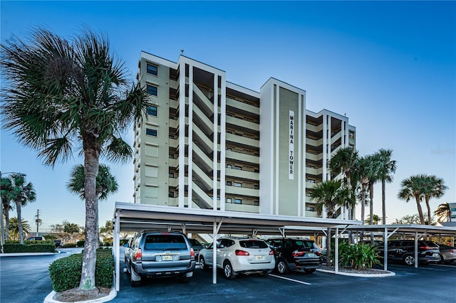 view of building exterior featuring covered parking