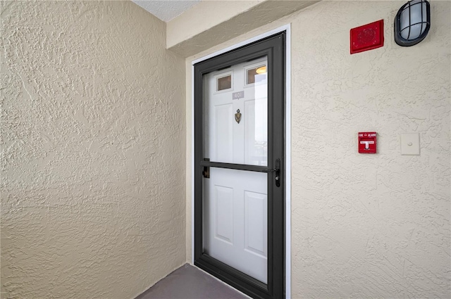 doorway to property with stucco siding