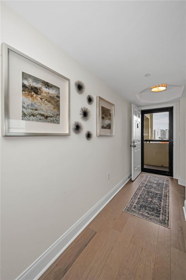 interior space with baseboards and wood finished floors