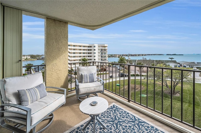 balcony featuring a water view