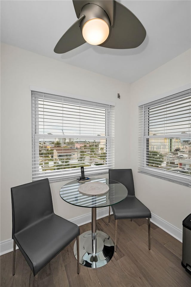 dining space with ceiling fan, plenty of natural light, wood finished floors, and baseboards