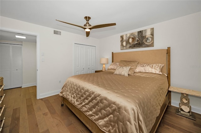 bedroom featuring a closet, visible vents, a ceiling fan, wood finished floors, and baseboards