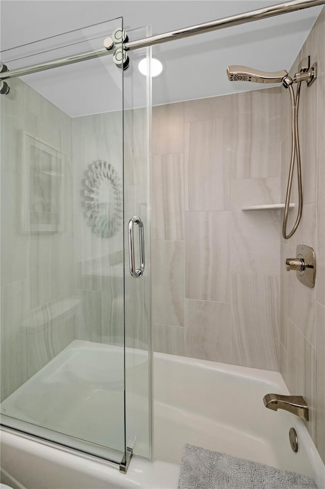 full bath featuring shower / bath combination with glass door